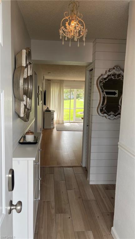 267 Quail Forest Boulevard, Unit 111 Naples, FL 34105 - Photo 3 of 41 a view of a kitchen from the hallway