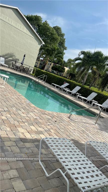267 Quail Forest Boulevard, Unit 111 Naples, FL 34105 - Photo 35 of 41 a view of a swimming pool with a yard and plants
