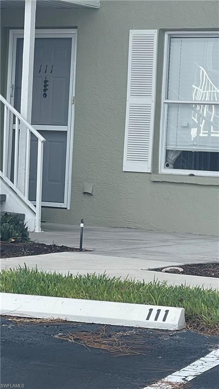 267 Quail Forest Boulevard, Unit 111 Naples, FL 34105 - Photo 38 of 41 a small white building and a street view