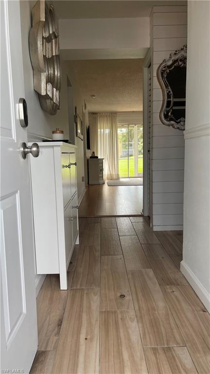 267 Quail Forest Boulevard, Unit 111 Naples, FL 34105 - Photo 4 of 41 a view of water heater room with wooden floor