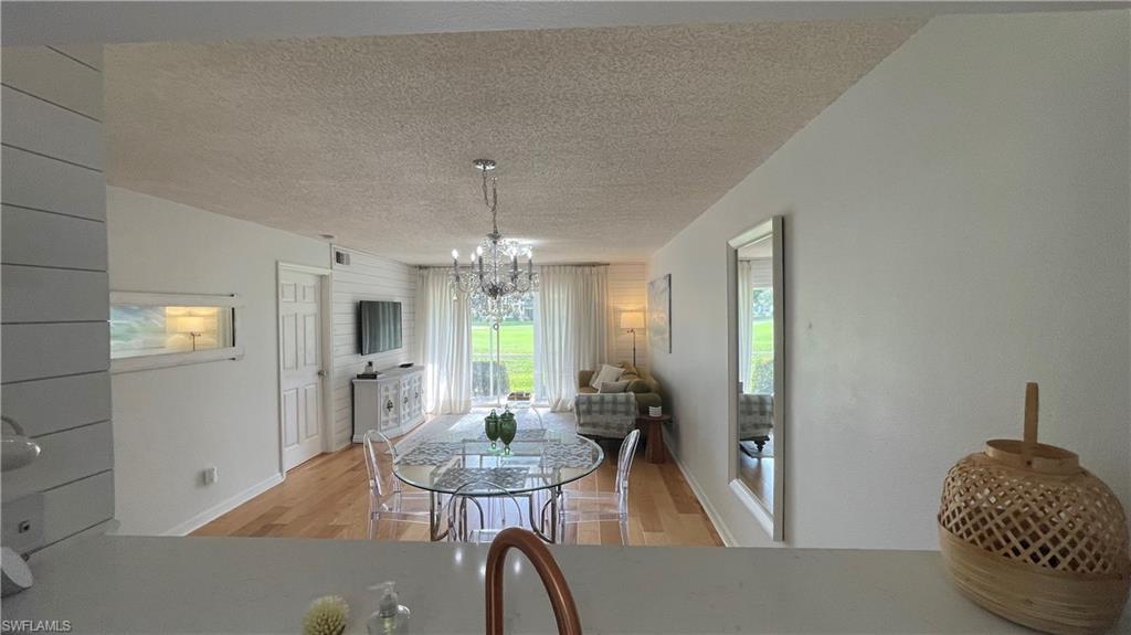 267 Quail Forest Boulevard, Unit 111 Naples, FL 34105 - Photo 5 of 41 a view of a livingroom with furniture and window