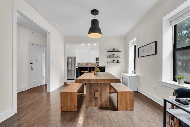 a living room with furniture a chandelier and a dining table