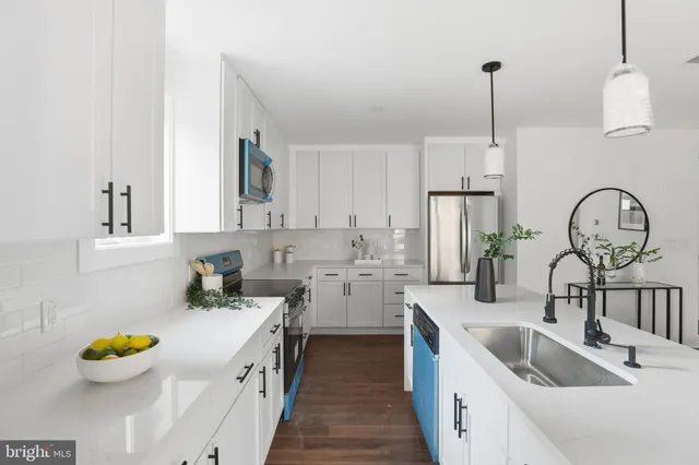 a kitchen that has a sink cabinets and window
