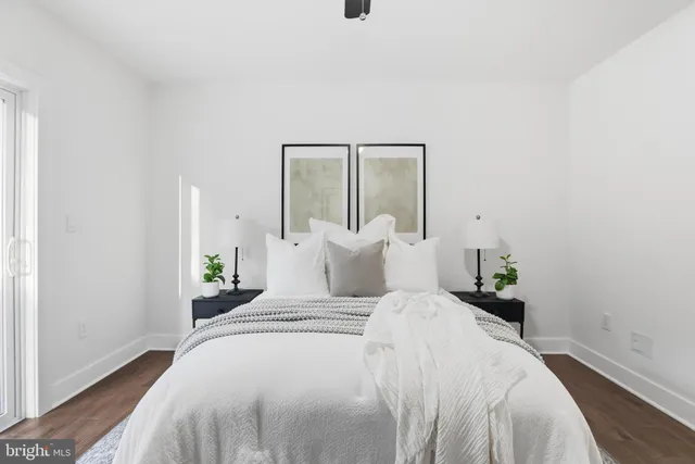 a bedroom with a bed and painting on the wall