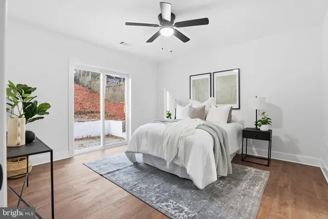 a bedroom with a bed and a potted plant