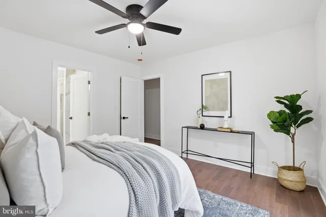 a bedroom with a bed and a potted plant