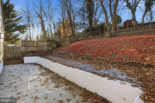 a view of a yard with wooden fence