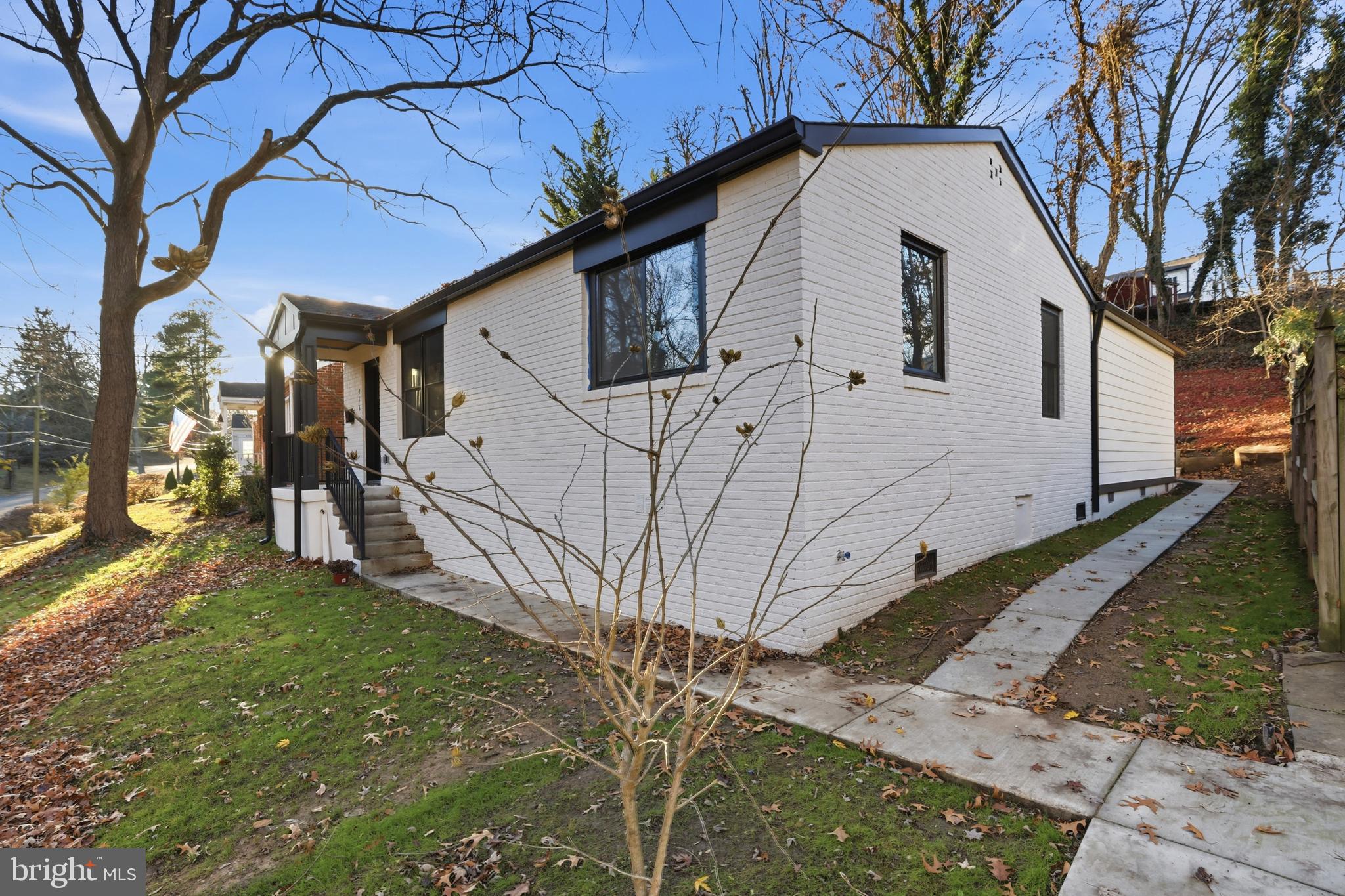 413 Williamsburg Drive Silver Spring, MD 20901 - Photo 4 of 33 a view of a white house with a large tree