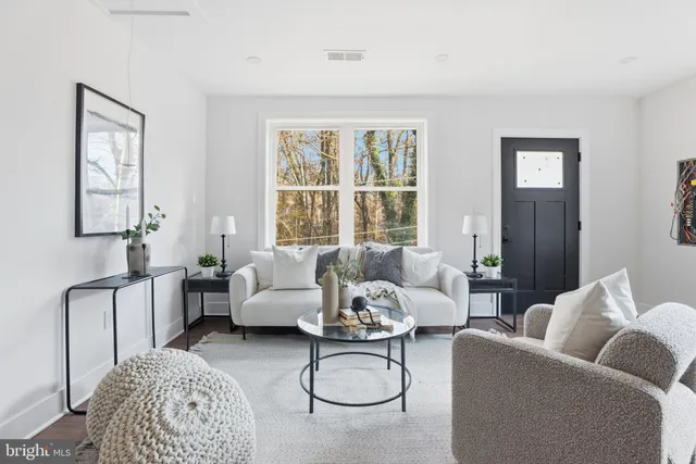 a living room with furniture ceiling fan and a window