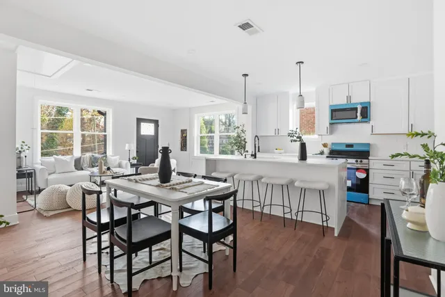 a dining room with furniture and wooden floor