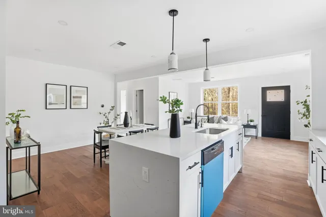 a open kitchen with sink cabinets and dining table