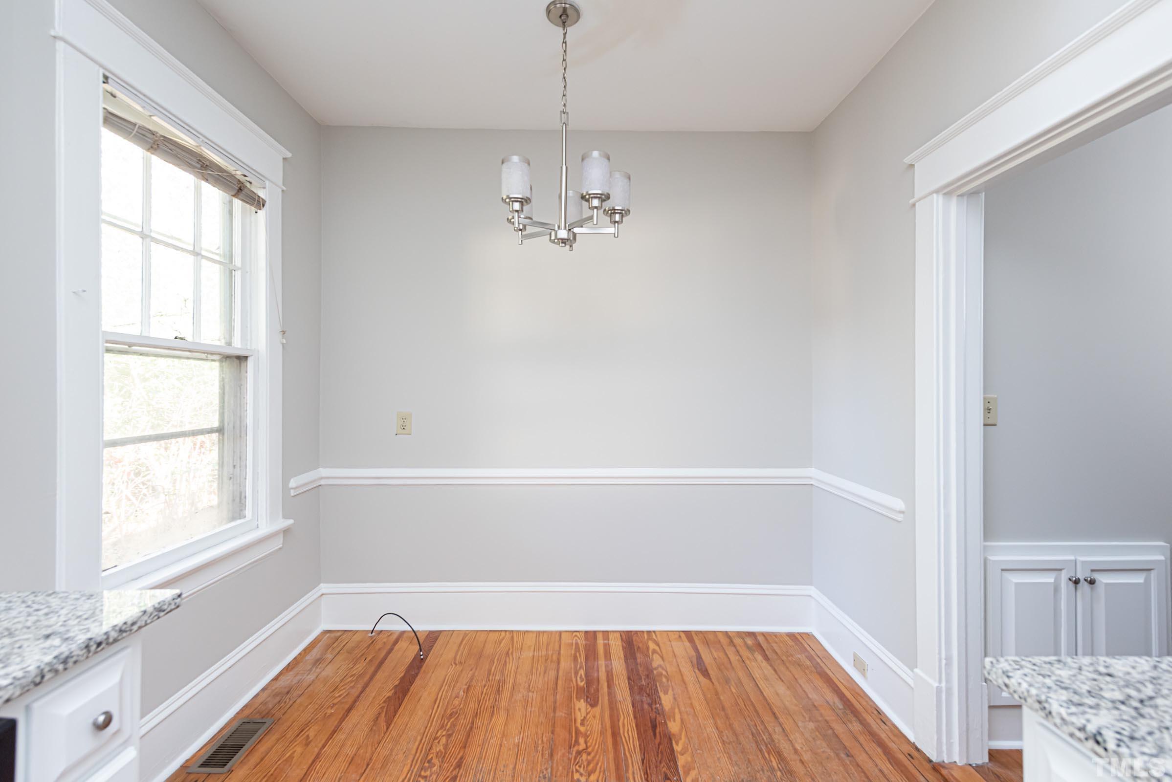619 Hinsdale Street Raleigh, NC 27605 - Photo 11 of 34 a bathroom with a bathtub a sink and a window