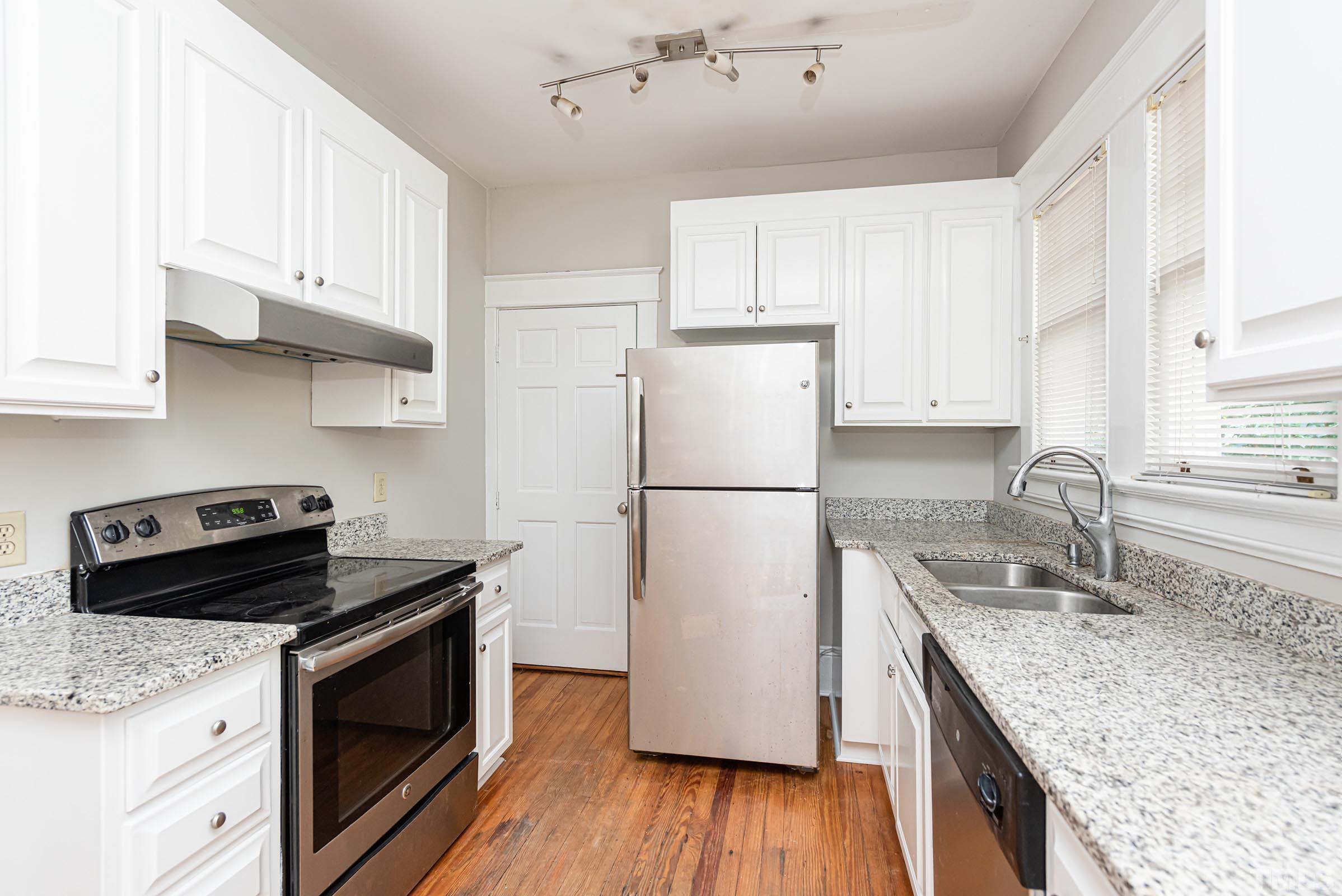 619 Hinsdale Street Raleigh, NC 27605 - Photo 12 of 34 a kitchen with a sink stove and refrigerator