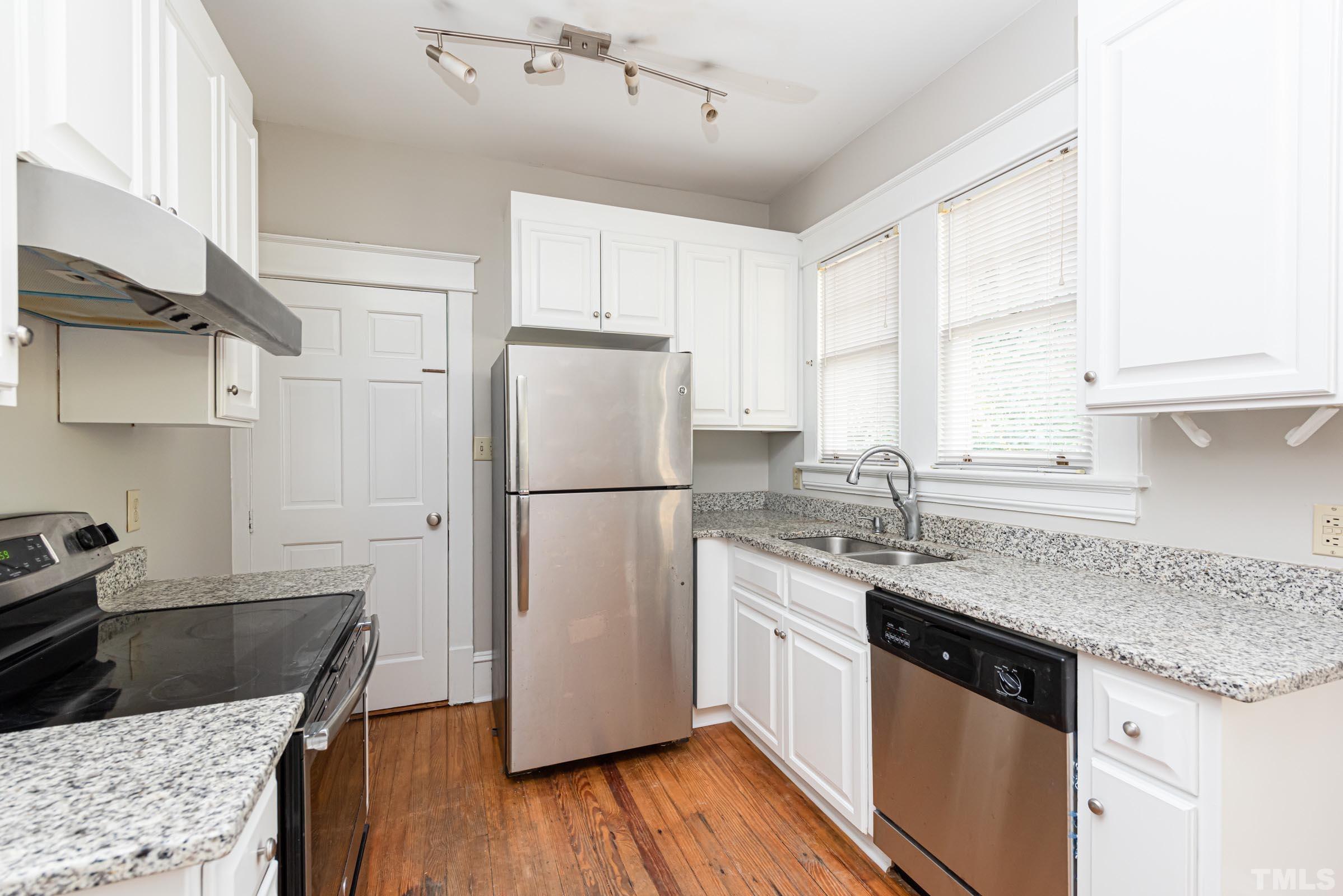 619 Hinsdale Street Raleigh, NC 27605 - Photo 13 of 34 a kitchen with a sink stove and refrigerator