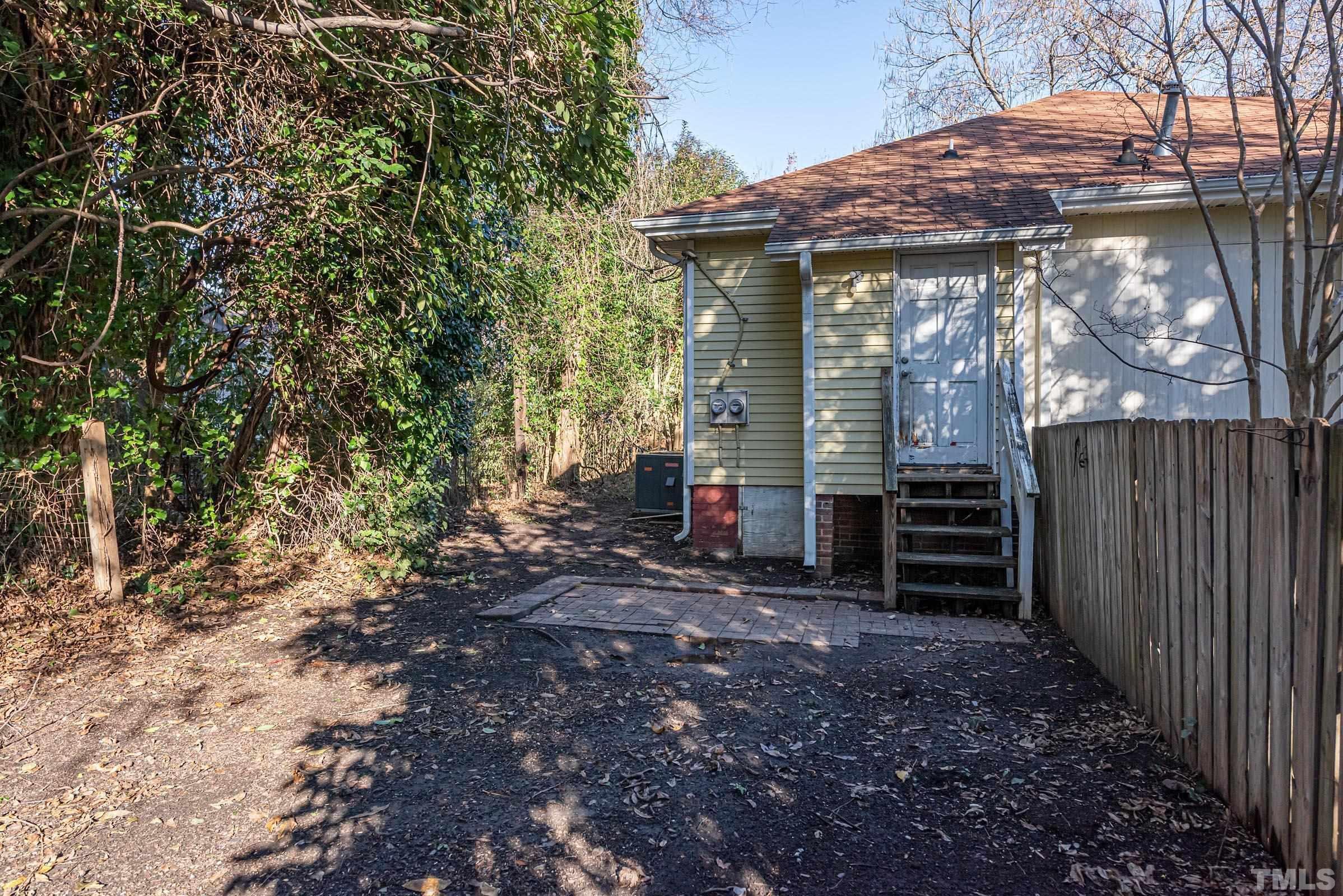 619 Hinsdale Street Raleigh, NC 27605 - Photo 15 of 34 a view of a house with a yard and wooden fence