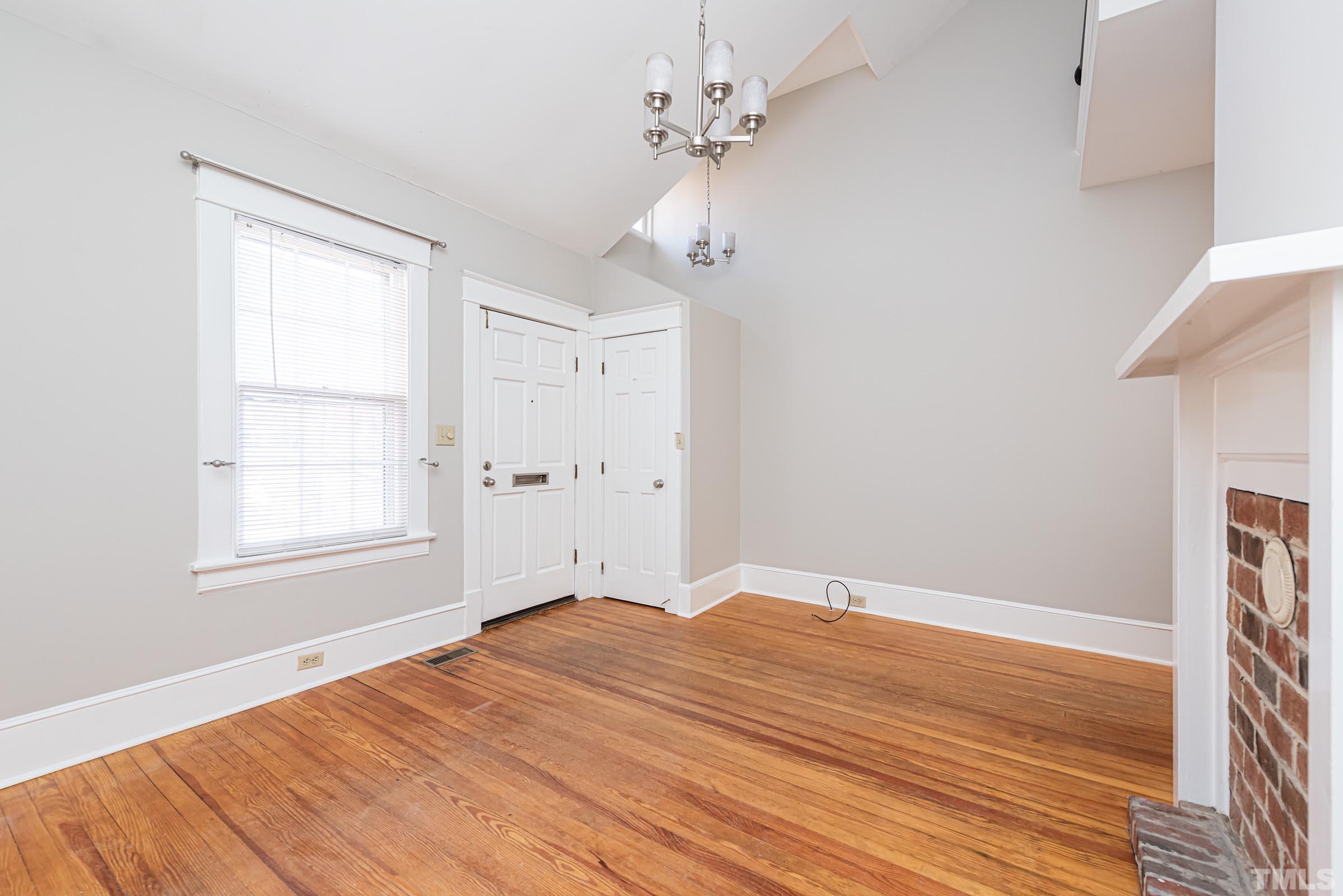 619 Hinsdale Street Raleigh, NC 27605 - Photo 4 of 34 a view of empty room with wooden floor and fan