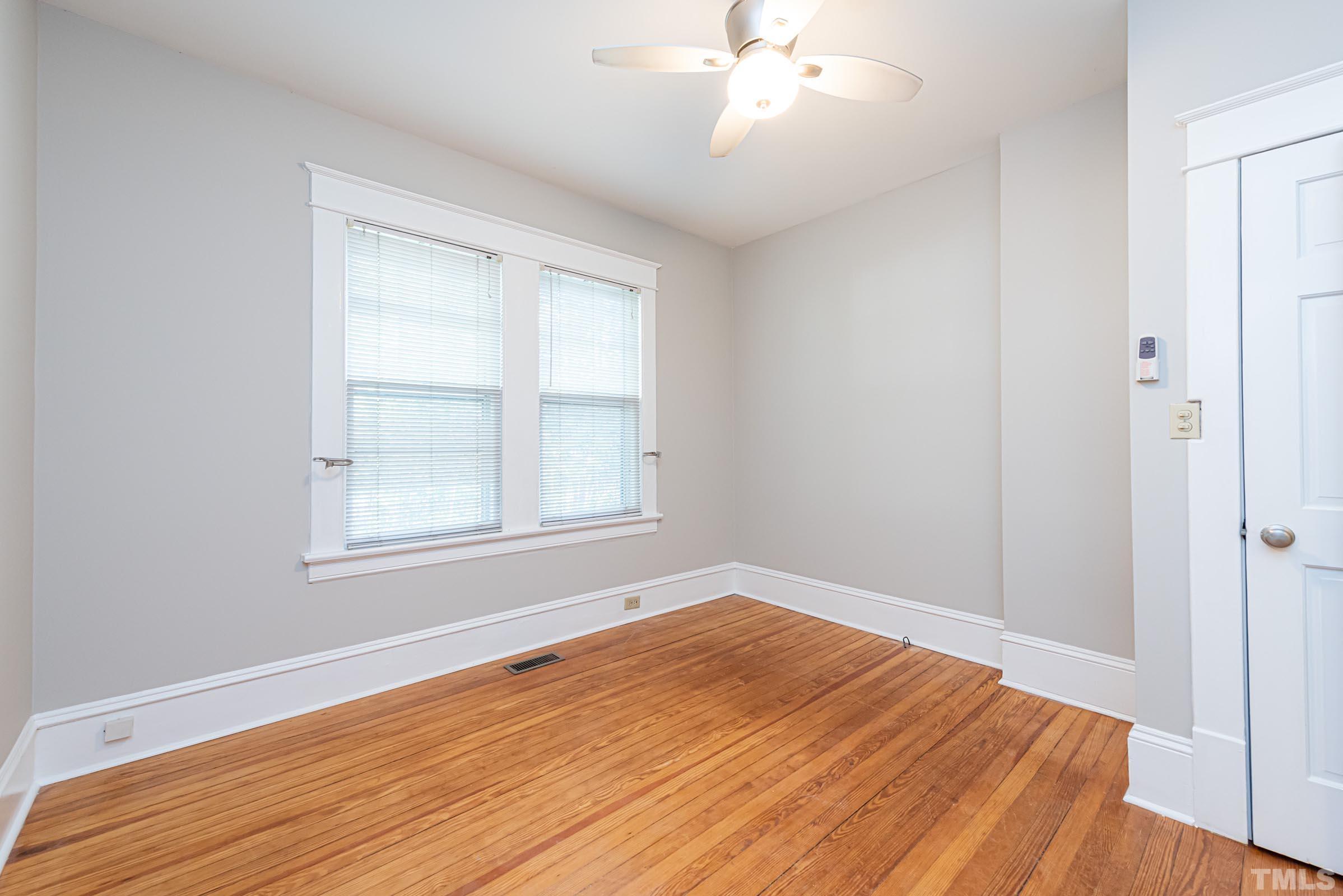 619 Hinsdale Street Raleigh, NC 27605 - Photo 6 of 34 a view of empty room with wooden floor and fan