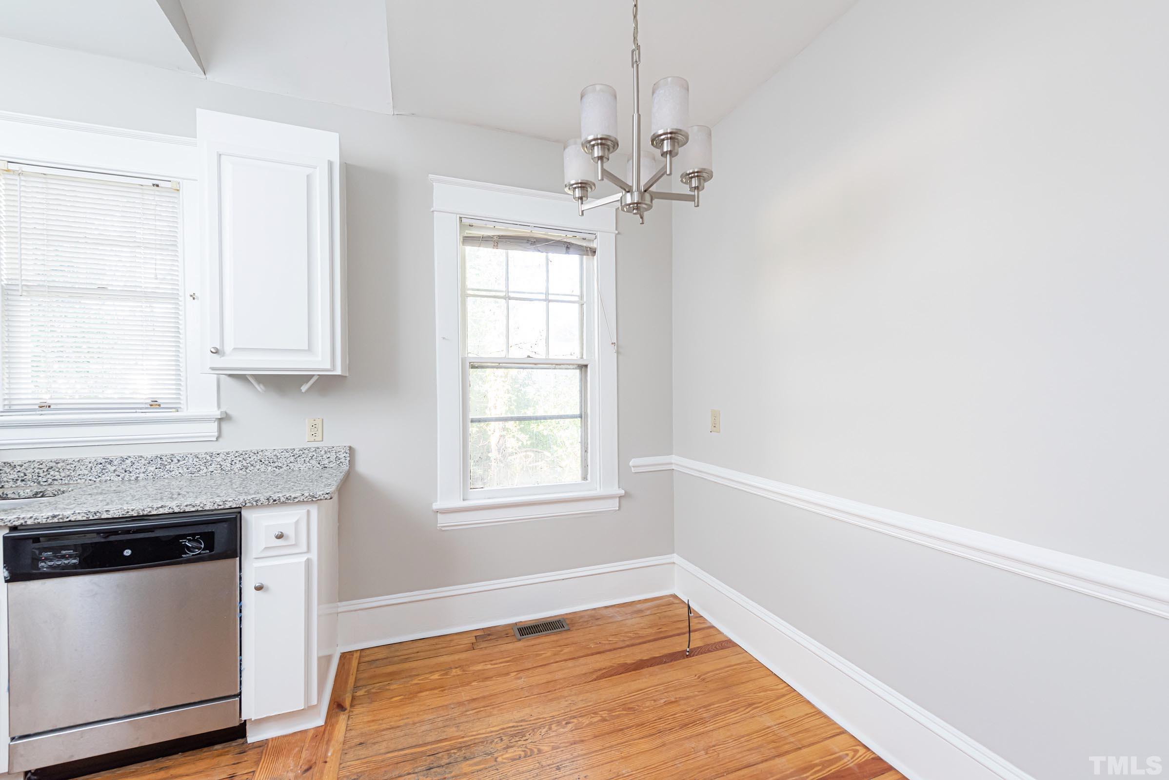 619 Hinsdale Street Raleigh, NC 27605 - Photo 10 of 34 a very nice looking room with a kitchen island wooden floor and window