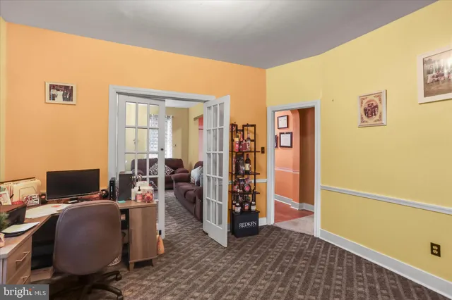 a view of a livingroom with workspace and a window