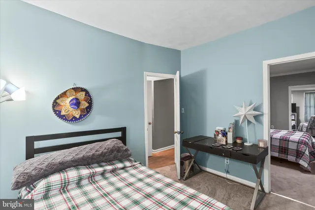 a bedroom with a bed and a lamp on table