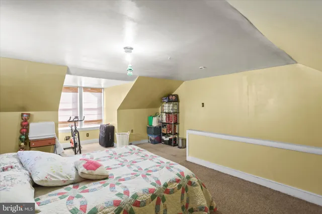 a bedroom with a bed and large windows