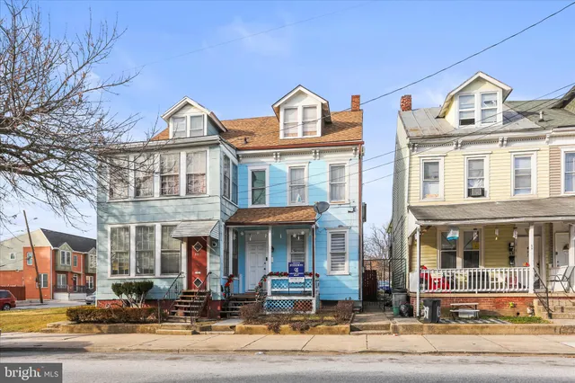 a front view of a residential apartment building with a yard