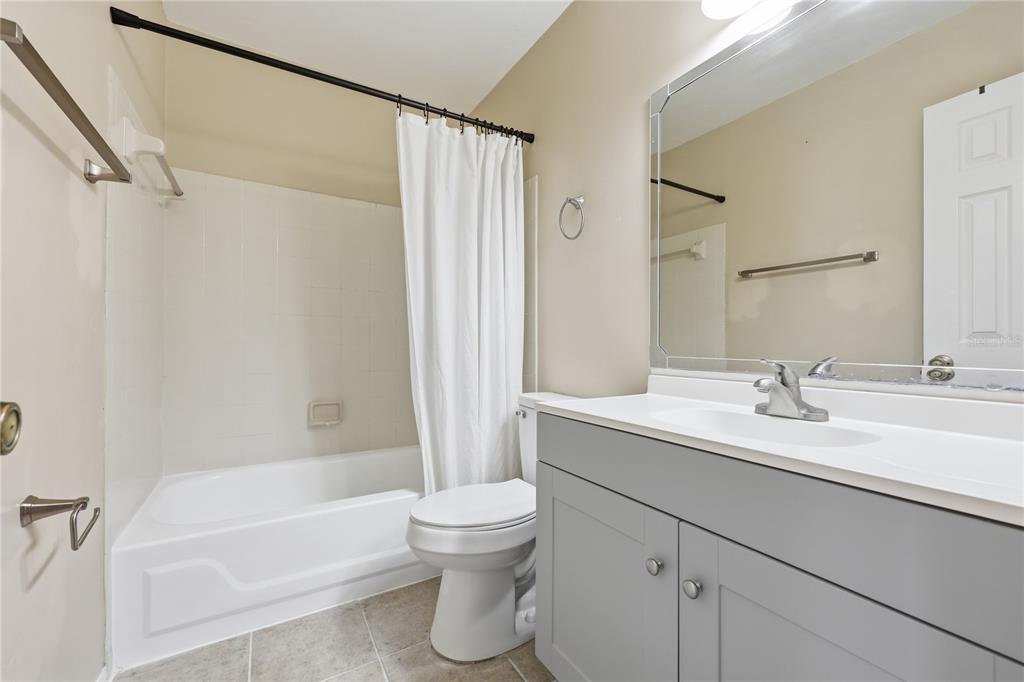 4427 Southwest 21st Lane Gainesville, FL 32607 - Photo 19 of 36 a bathroom with a sink toilet and shower