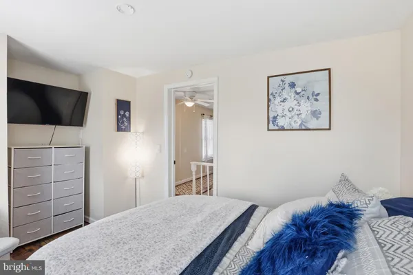 a bedroom with a bed and a television