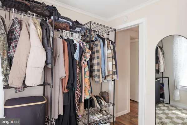 a view of walk in closet with clothes