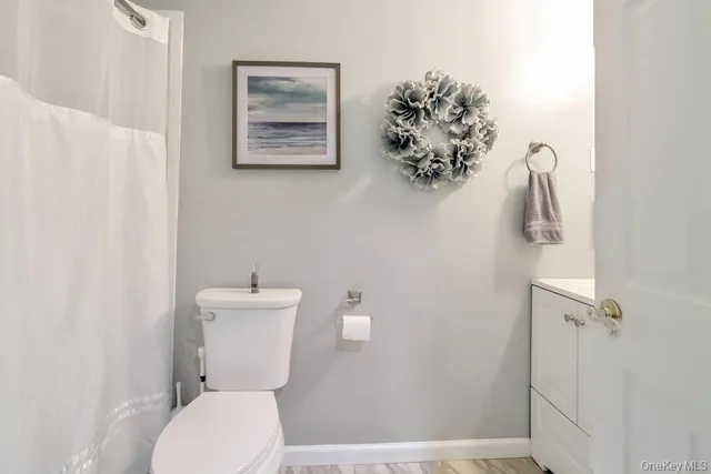 a white toilet sitting next to a bathroom sink