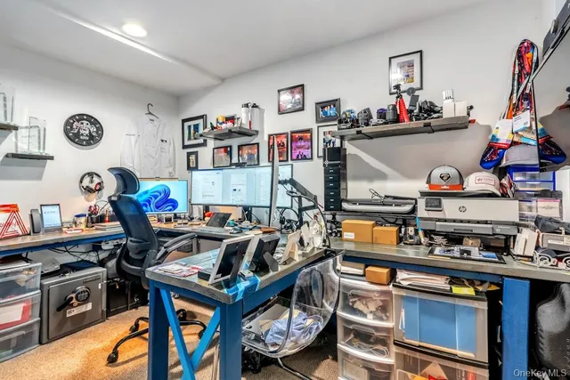 a work place with furniture a rug and a wooden floor