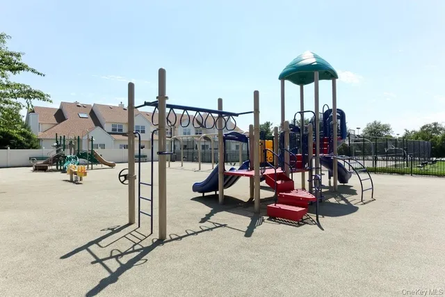 a view of a swimming pool with a bench and wooden fence