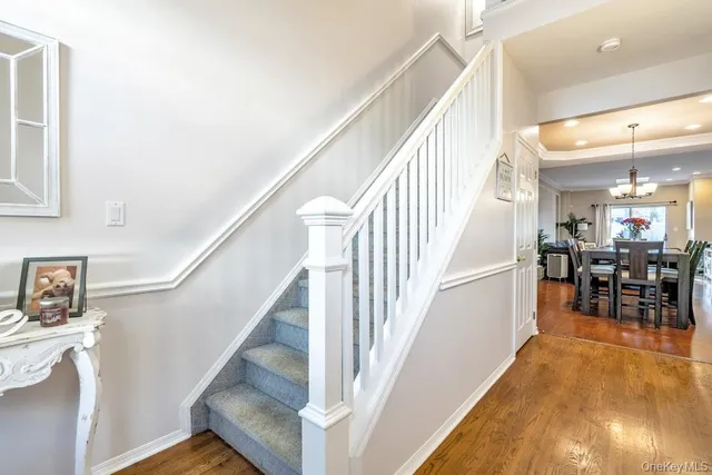 a view of entryway and hall with wooden floor