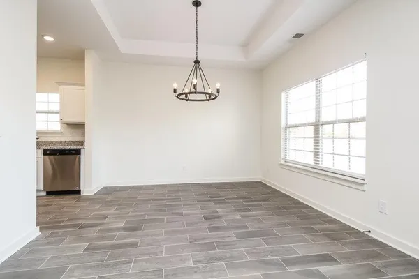 a view of a room with a window and a wooden floor