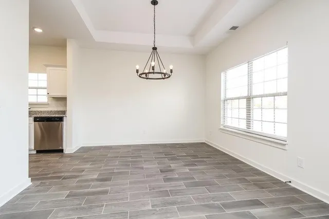 a view of a room with a window and a wooden floor