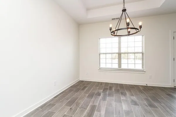 a kitchen with stainless steel appliances granite countertop a stove top oven a sink dishwasher and a refrigerator with wooden cabinets