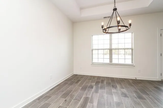 a kitchen with stainless steel appliances granite countertop a stove top oven a sink dishwasher and a refrigerator with wooden cabinets