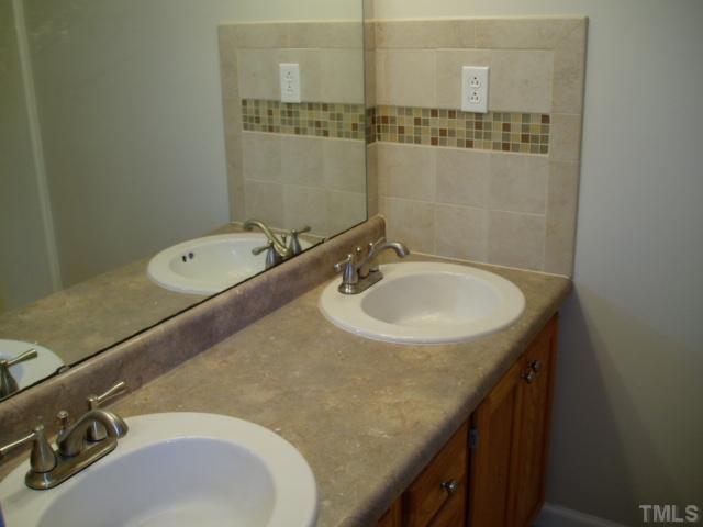 7309 Shawan Road Wendell, NC 27591 - Photo 10 of 12 Hall bath has all new fixtures and custom tile work.