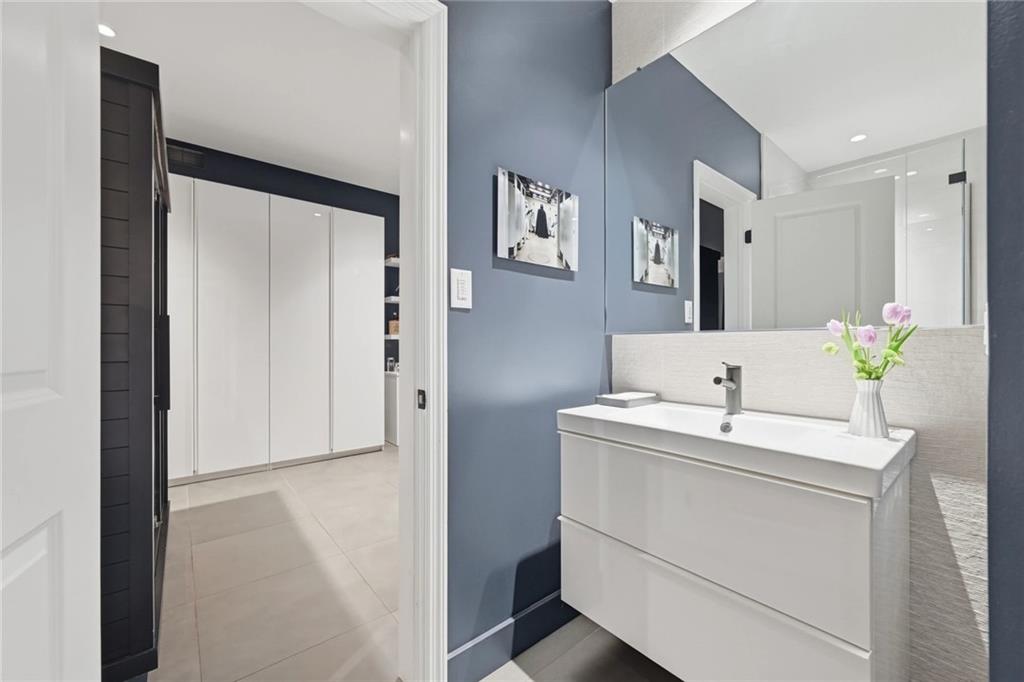 810 Persimmon Road Sewickley, PA 15143 - Photo 41 of 49 The lower-level full bath serves the office suite and features a floating white vanity, textured tile surround, and walk-in glass shower with matte black hardware.