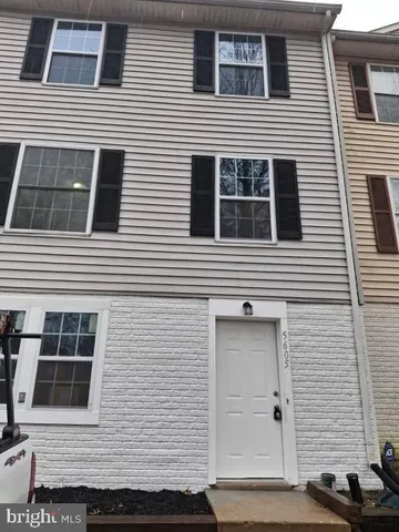 a view of a house with more windows and brick walls