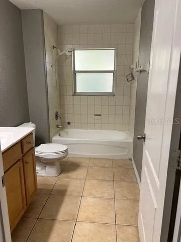 a bathroom with a bathtub and toilet