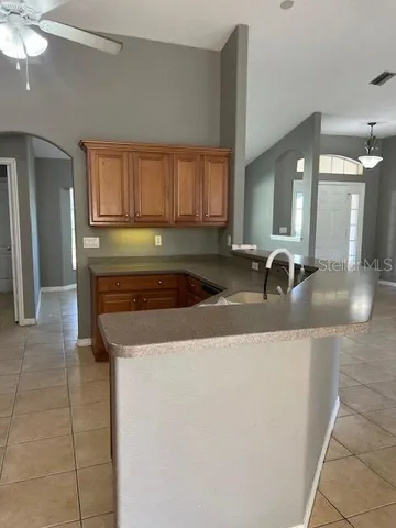 a kitchen with stainless steel appliances granite countertop a sink and a refrigerator