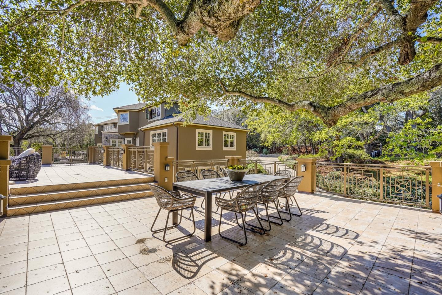 540 Moore Road Woodside, CA 94062 - Photo 15 of 85 a view of a patio with table and chairs with wooden fence and plants