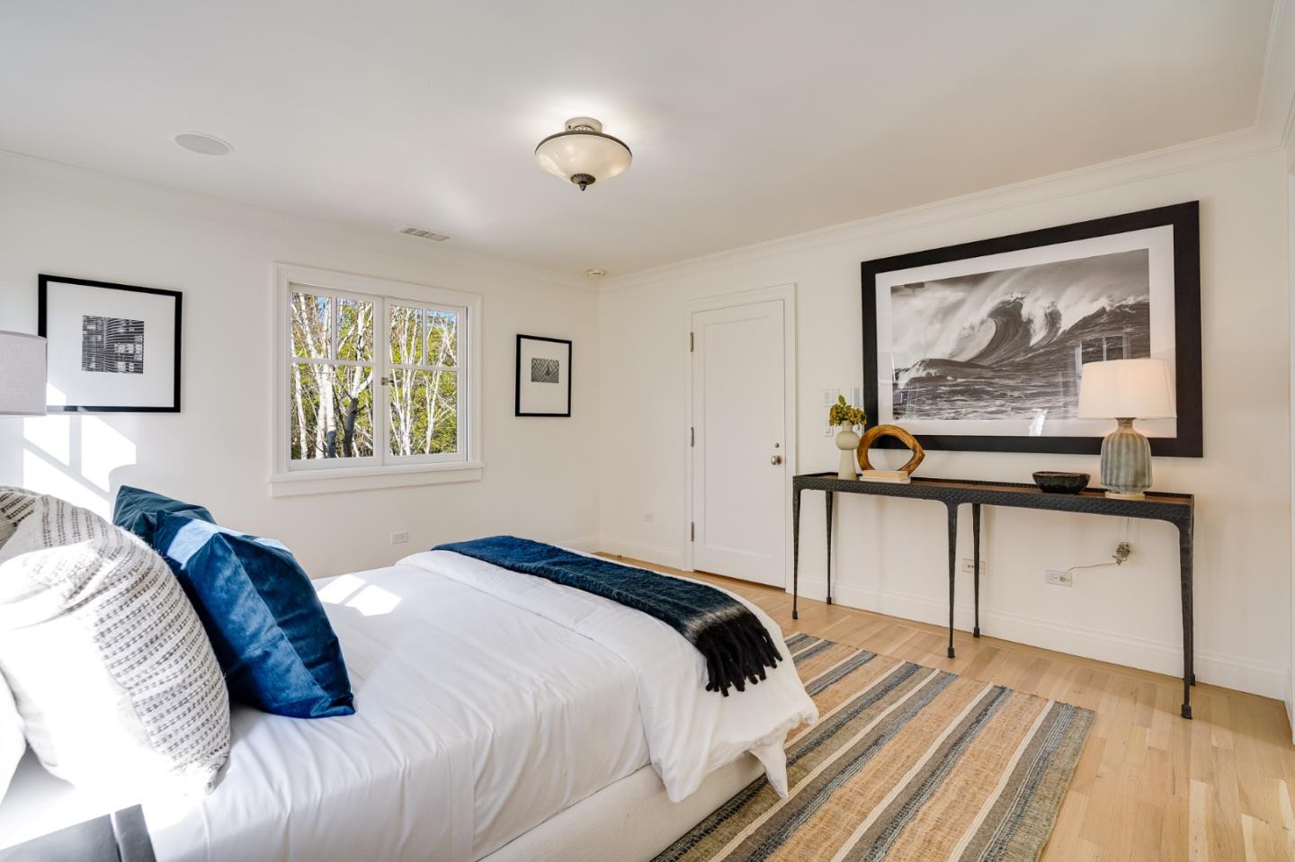 540 Moore Road Woodside, CA 94062 - Photo 44 of 85 a bedroom with a bed and a painting on the wall