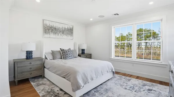 a bedroom with a large bed and a window