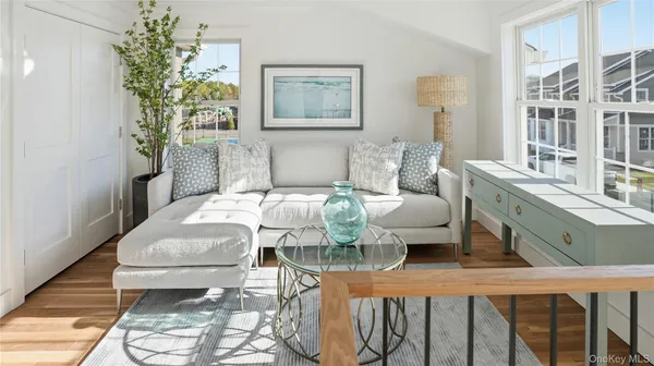a living room with furniture and a potted plant