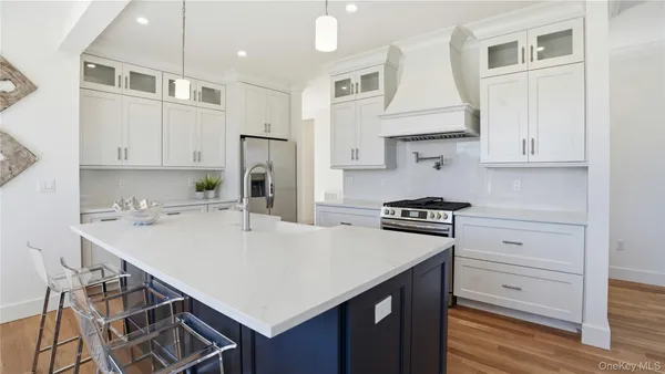 a kitchen with a stove a sink and a refrigerator