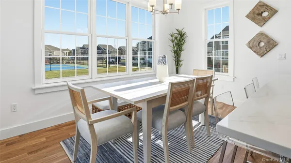 a view of a dining room with furniture window and wooden floor