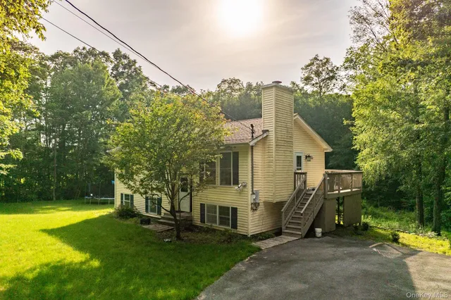 a view of a house with a yard balcony and sitting area