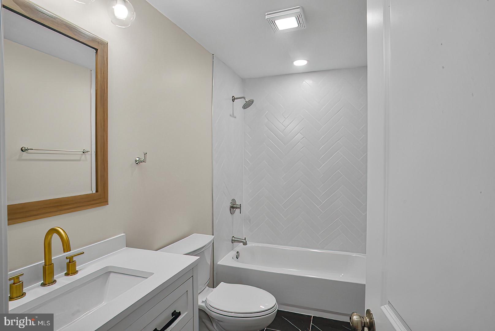 3316 Fairview Road Baltimore, MD 21207 - Photo 12 of 41 a bathroom with a sink toilet a mirror and shower